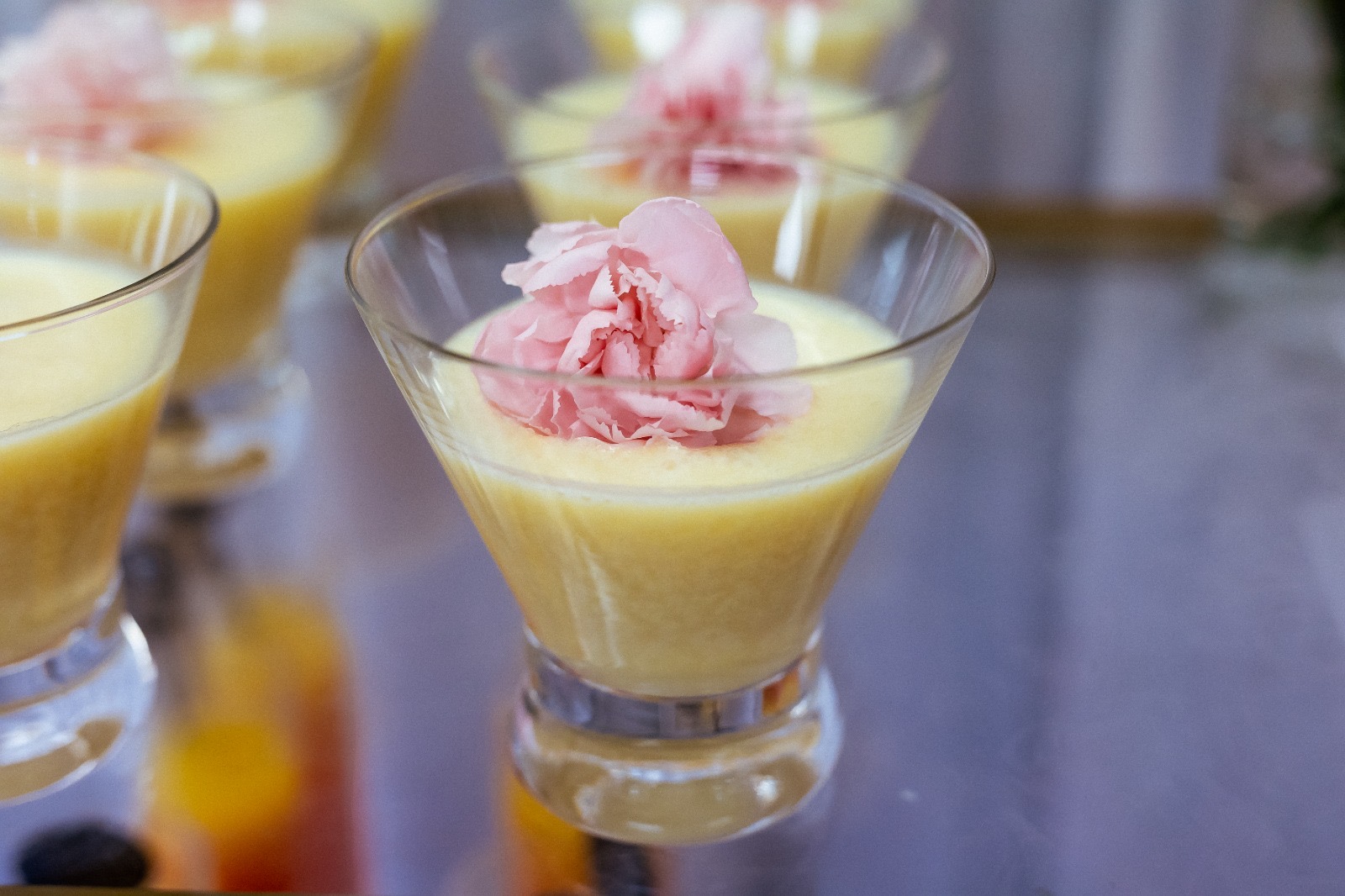 Elegant dessert drink with pink floral garnish