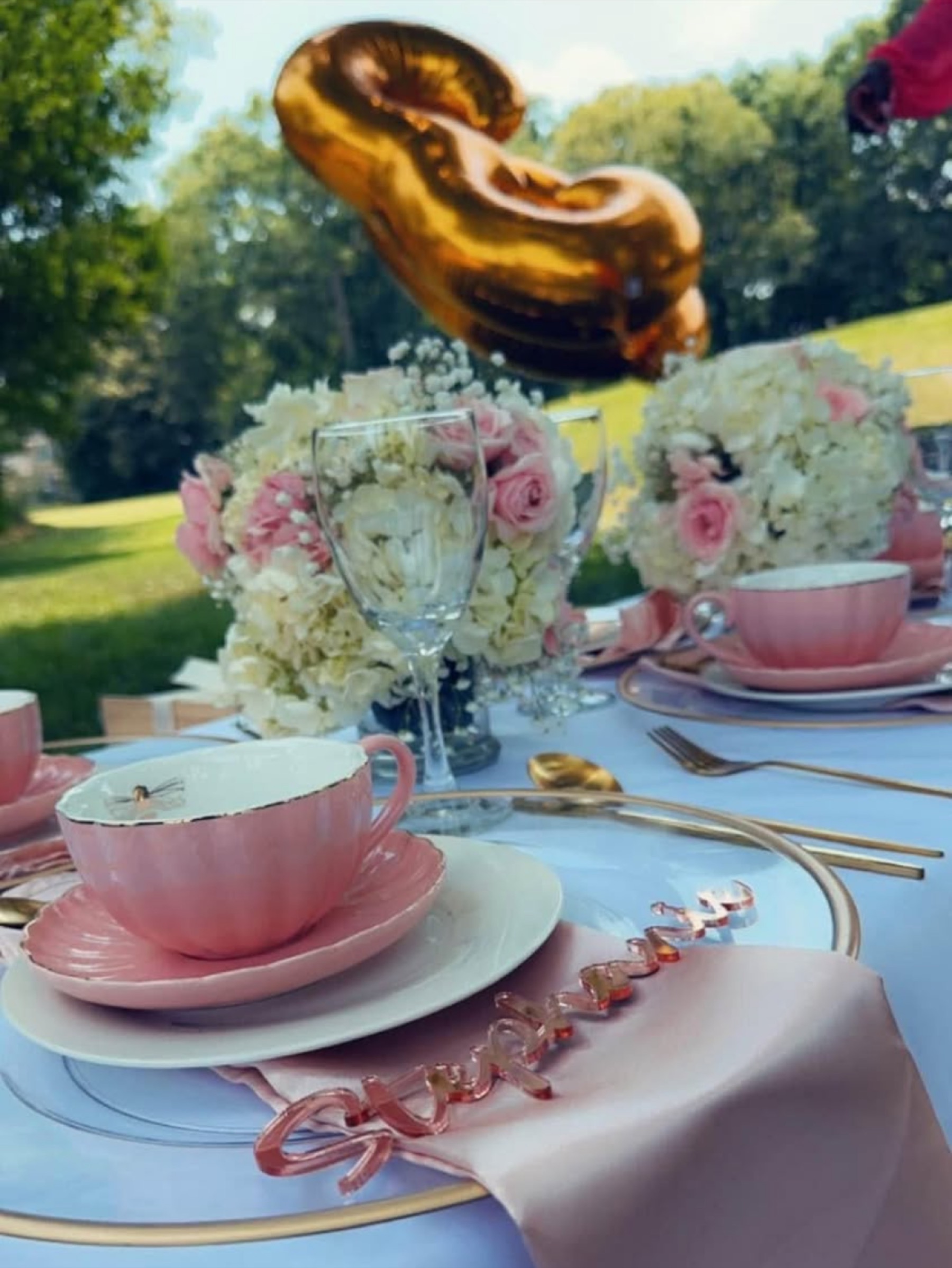 Pink and gold luxury picnic tablescape with florals